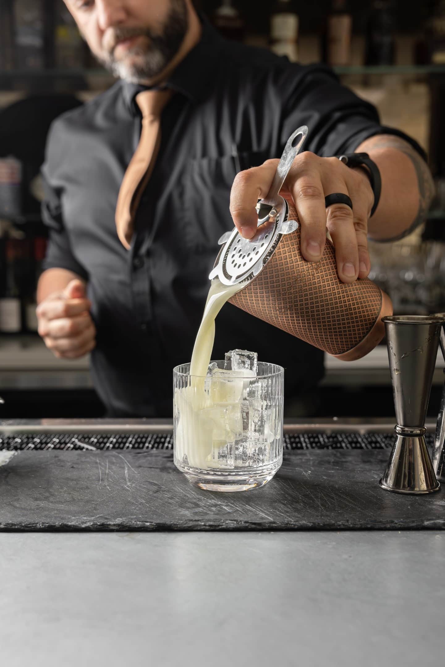 The bartender pouring